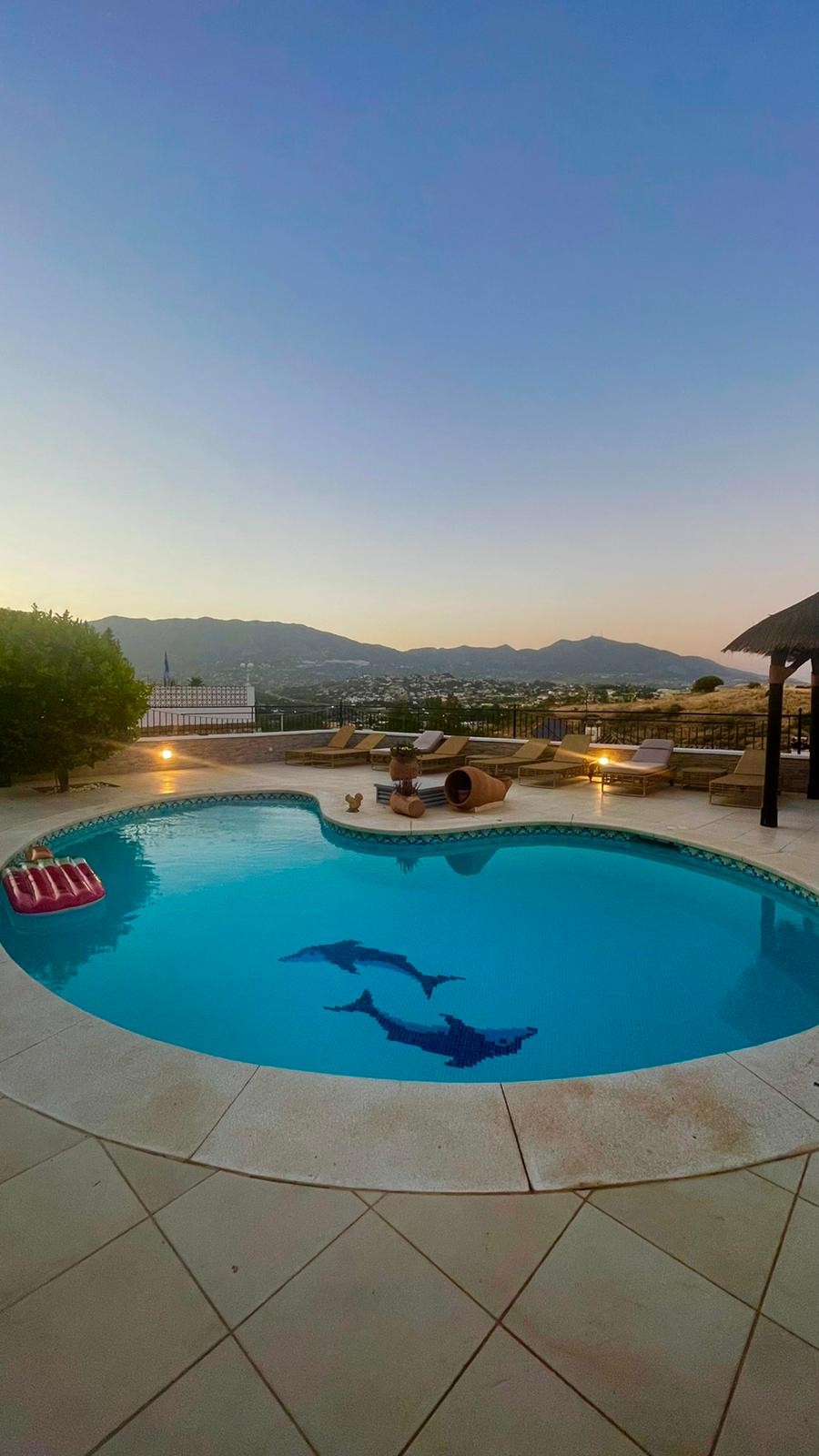 Pool at dusk with mountain lights